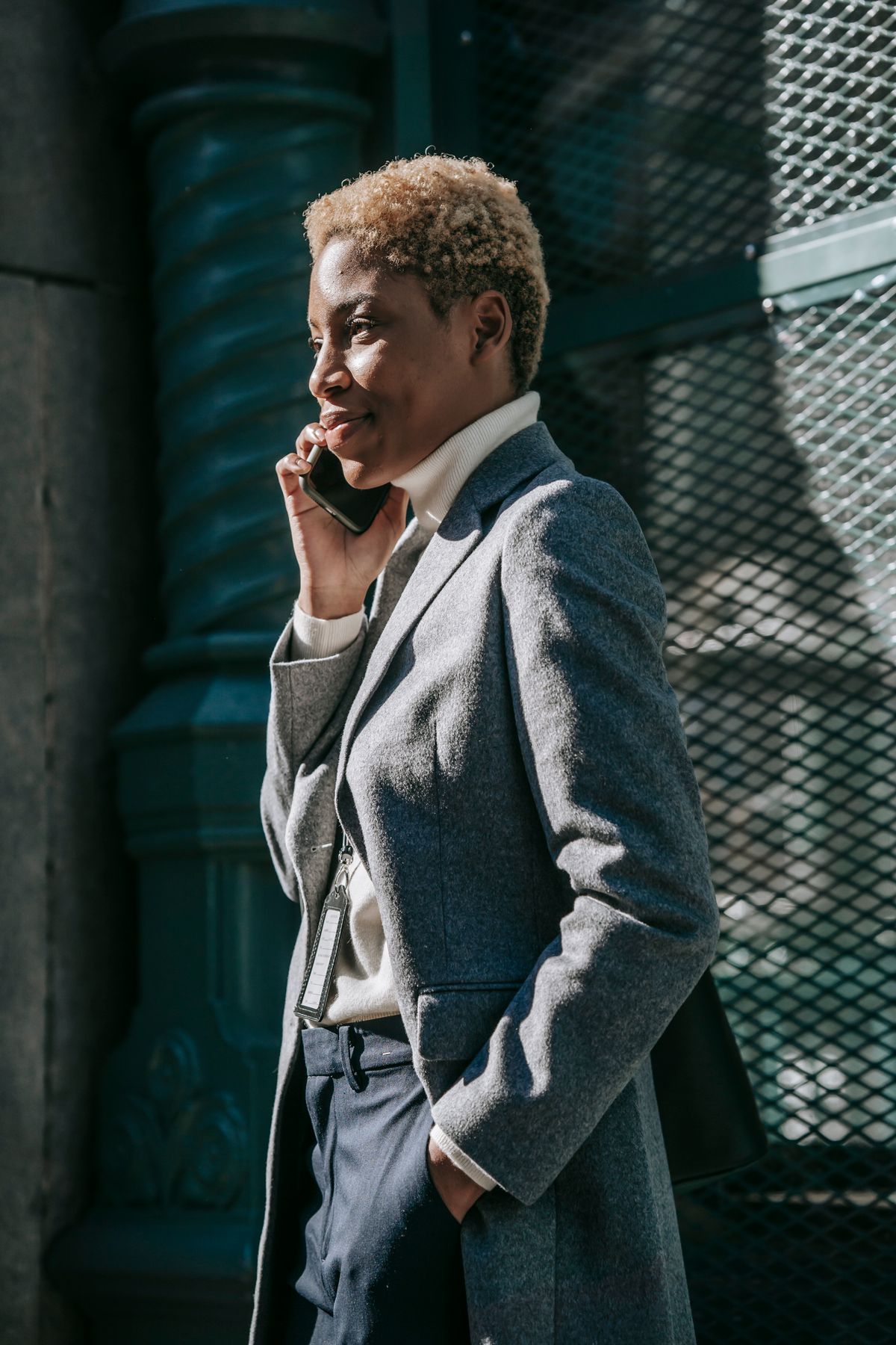 Black woman making a phone call on a city street